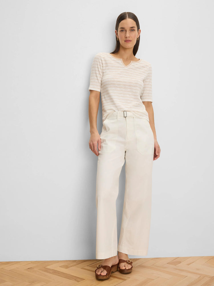 Cream wide-leg belted ankle pants with a rectangular buckle and side pockets.
