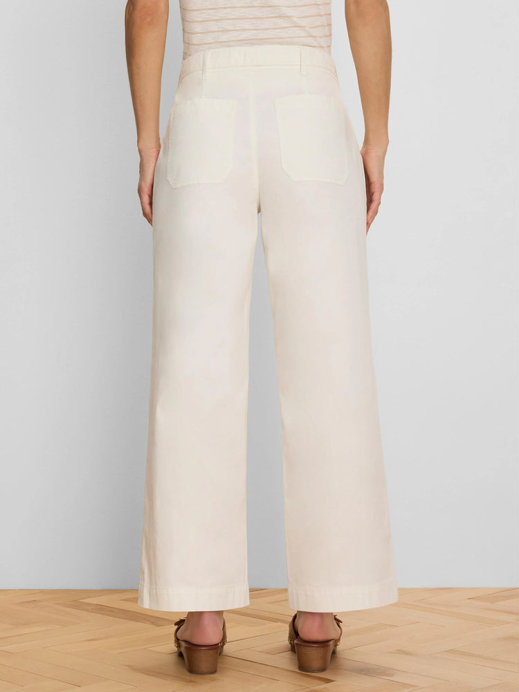 Cream wide-leg ankle pants, back view. Features belt loops and two back patch pockets.