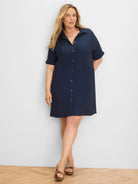 Navy collared button-down dress with cuffed short sleeves, full button placket, and above-knee length.