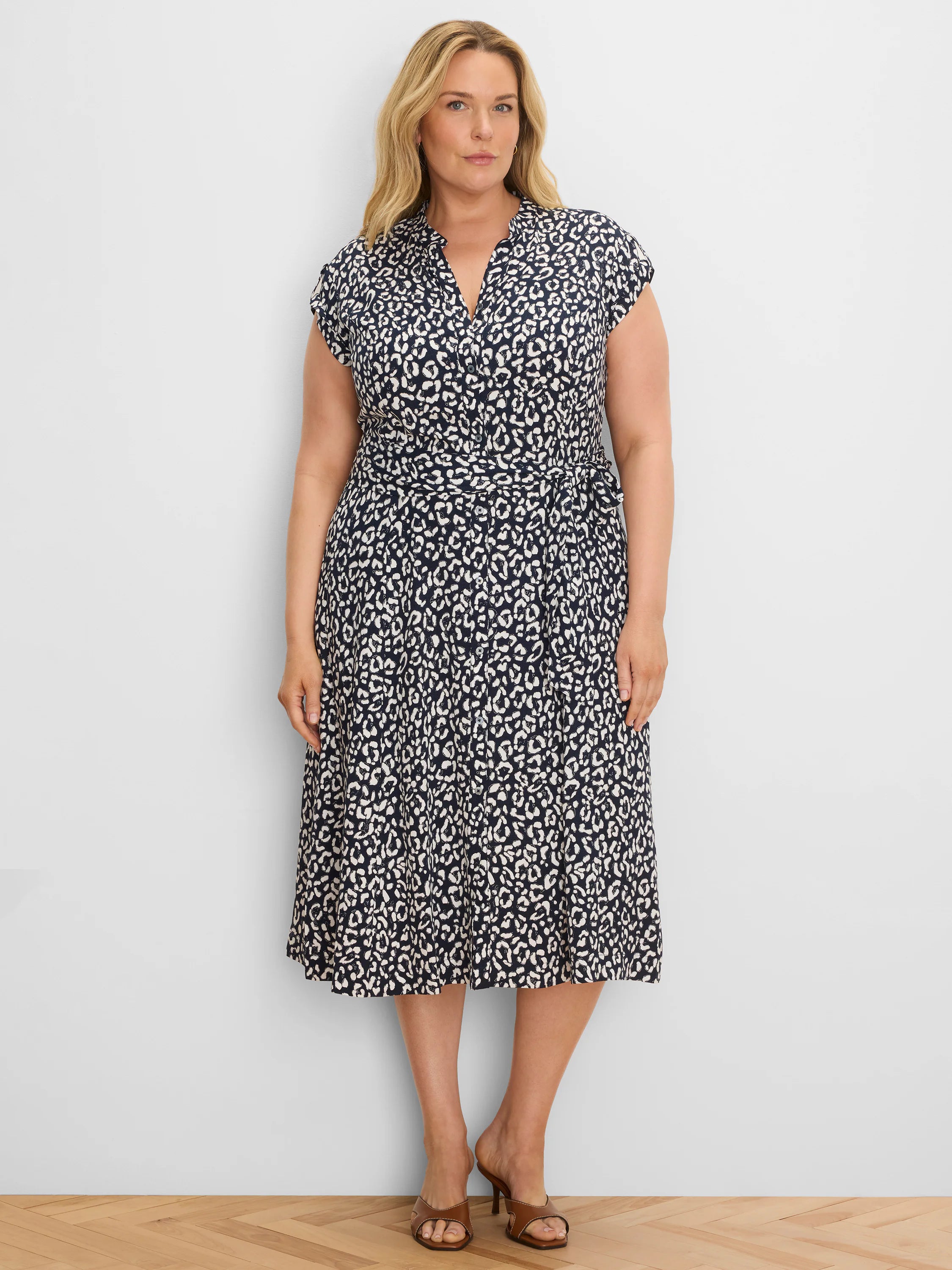Navy and off-white leopard sketch midi dress with V-neck, short sleeves, button front, and tie waist.