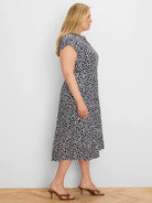 Navy and white sketched leopard print midi dress with cap sleeves and a cinched waist.