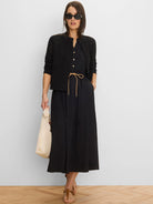 Black midi-length dress with a V-neck, golden front buttons, and a tan drawstring waist.