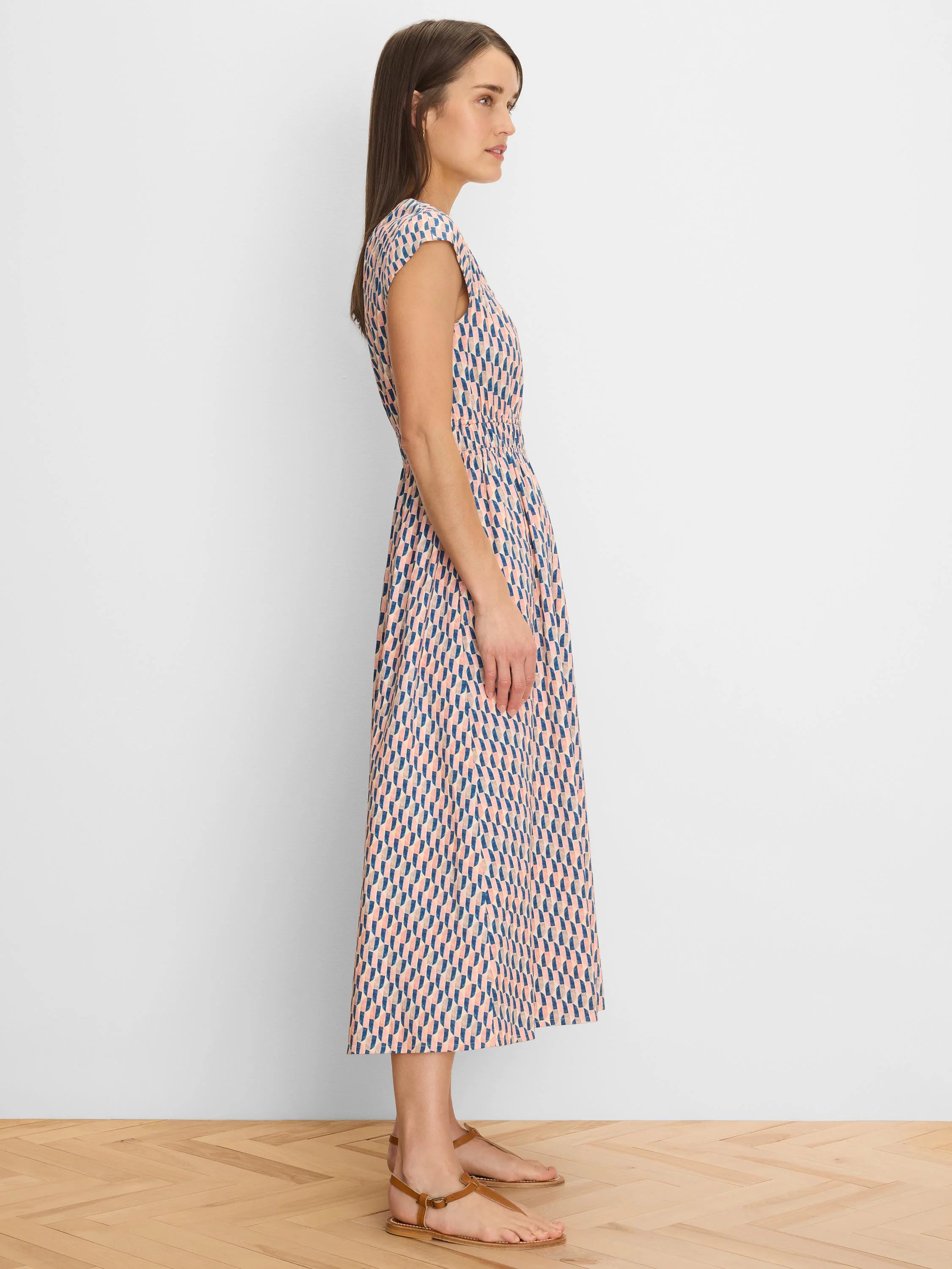 Cap sleeve midi dress with a gathered waist, featuring a geometric pattern in muted blue, peach, and tan.