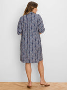 Navy dress with scattered light blue and peach block pattern. Knee-length, short sleeves, relaxed fit.