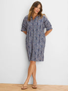 Above-knee dark blue dress with a collared V-neck and short sleeves, featuring a speckled pattern in blues, pink, and white.