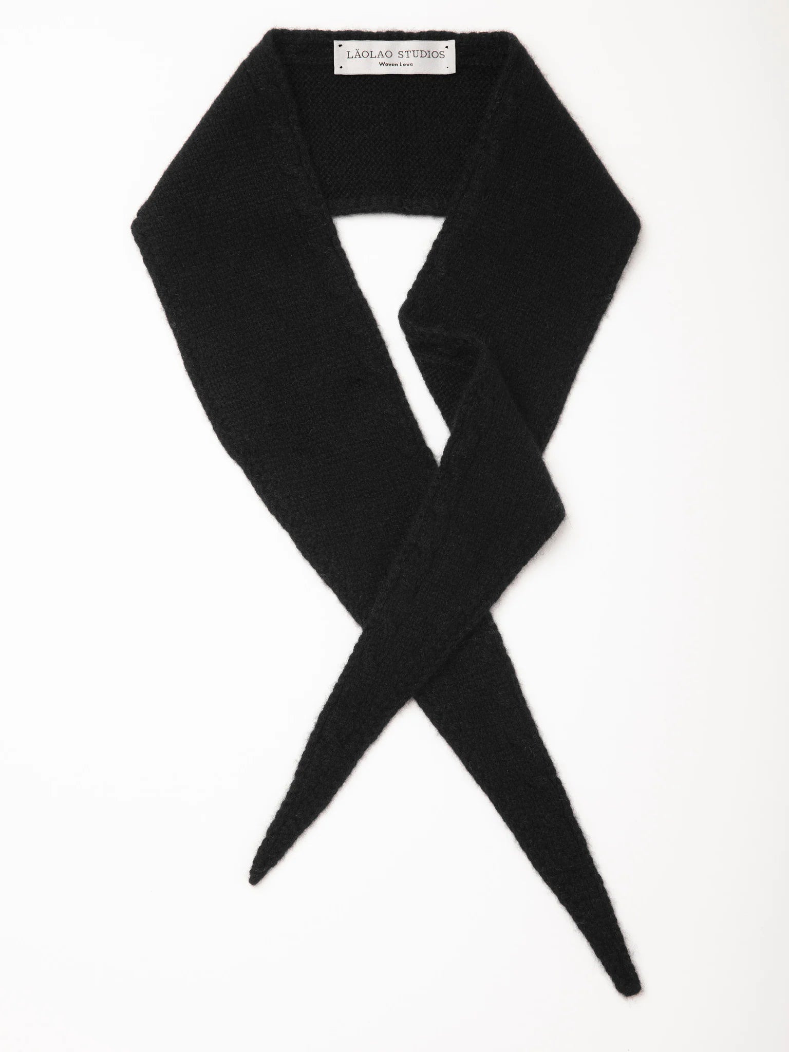 Black fuzzy knit mini scarf, folded to form an X with pointed ends.