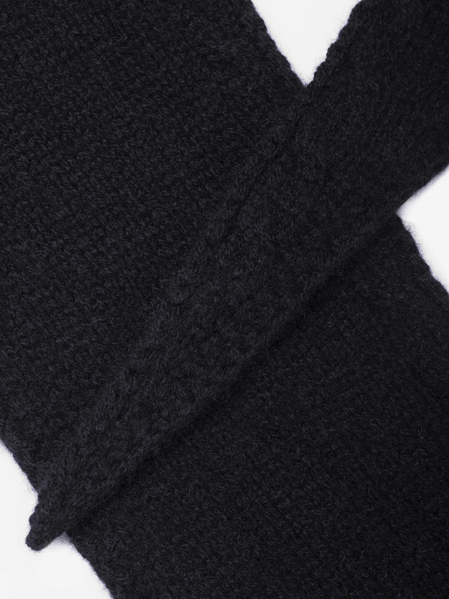 Black knitted scarf with a prominent fuzzy texture, folded.