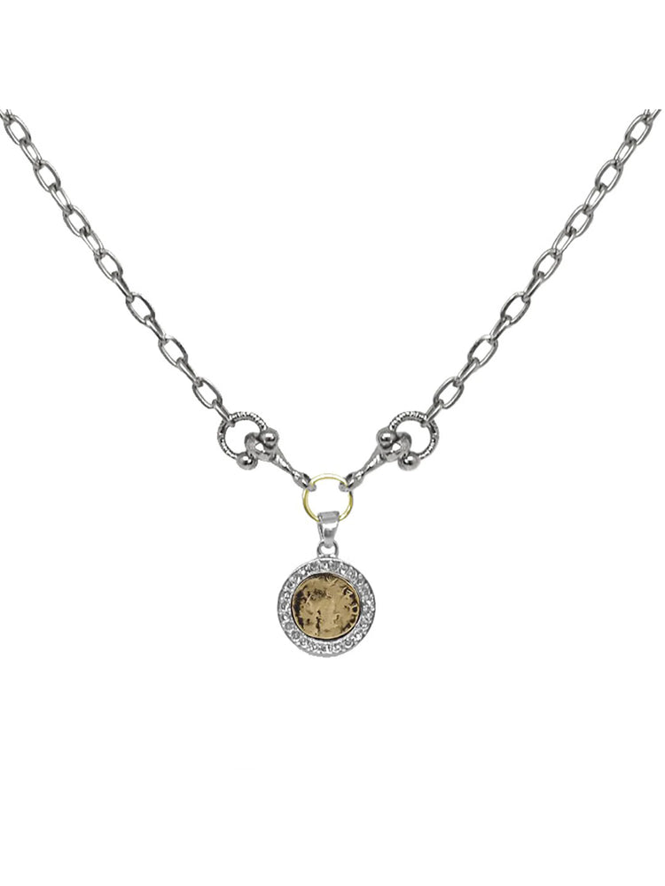 Silver chain necklace with a circular, antique gold coin pendant framed by small, clear stones.