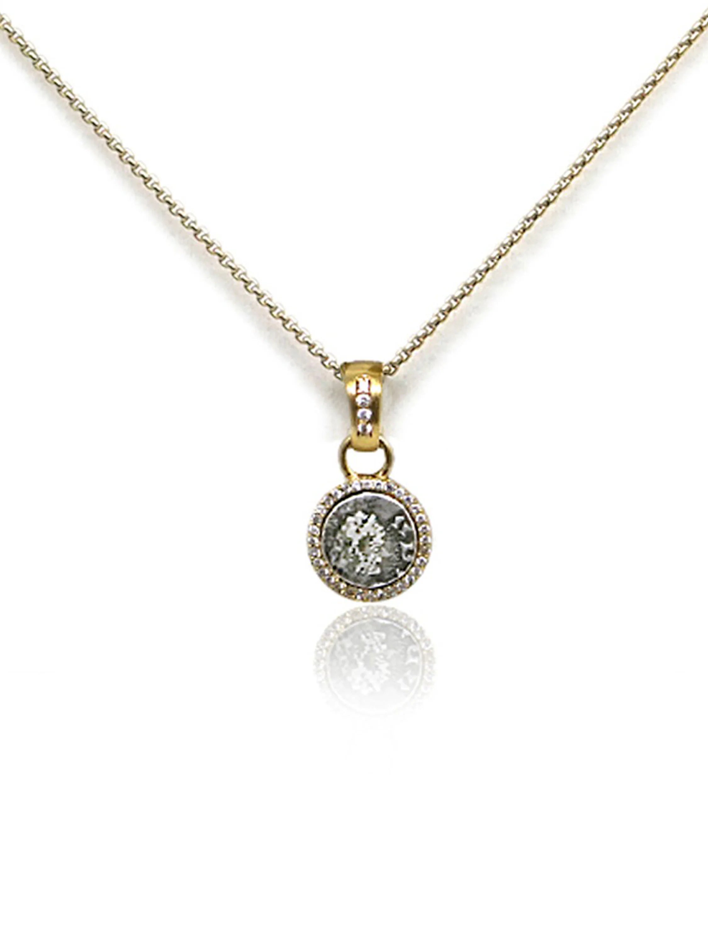 Gold chain and circular pendant.  Pendant features a gray coin-like center, framed by small clear stones and gold.