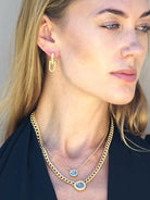 Gold necklace with two coin pendants; one small, one larger.  Features a thicker gold chain.