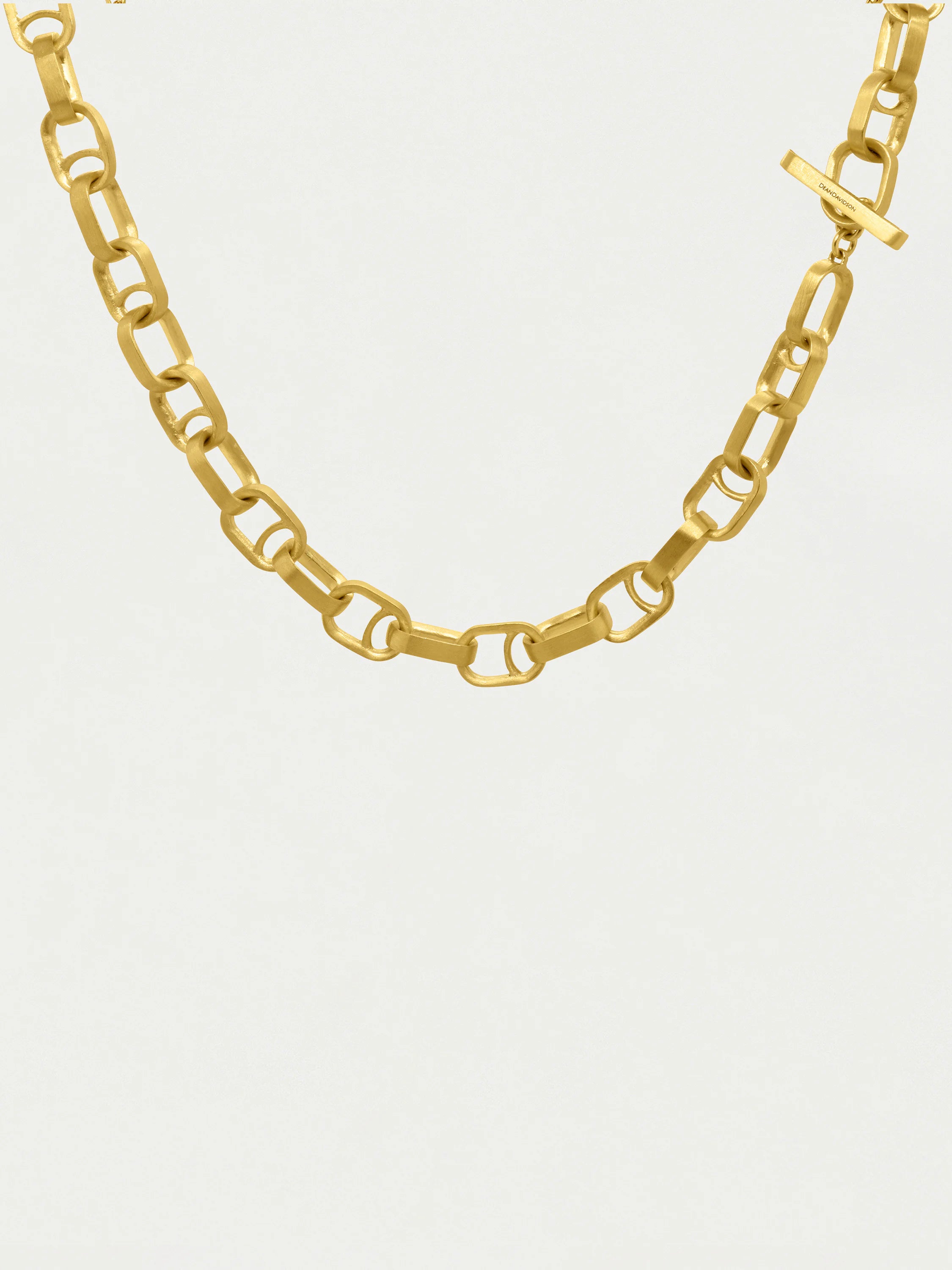 Gold, matte finish necklace.  Interlocking rectangular links,  bar clasp with logo.