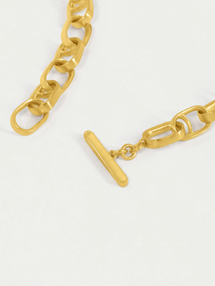 Gold interlocking chain necklace with a T-bar clasp.