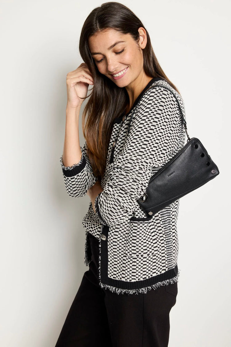 Black pebbled leather clutch, rectangular, with prominent dark metal rivets on the front and a top zipper closure.