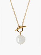 Gold chain necklace with a large white pearl and gold toggle clasp.