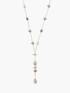 Grey, beige, and white pearls on a gold chain; Y-shaped design with larger pearls at bottom.