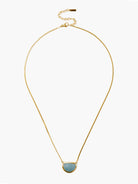 Gold chain necklace with a light blue, semi-circular moonstone pendant.