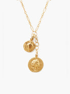 Gold necklace with textured chain. Two gold charms: a smaller round disc with a raised design, and a larger coin with a...