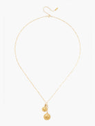 Delicate gold chain necklace with two layered gold disc charms: a small heart and a larger coin with a profile.