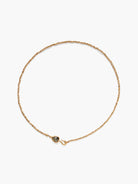 Gold beaded chain necklace with dark gray pear-shaped labradorite gemstone clasp.
