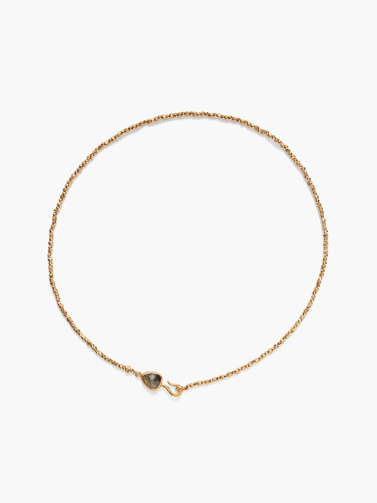 Gold beaded chain necklace with dark gray pear-shaped labradorite gemstone clasp.