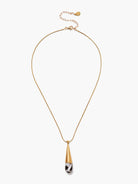 Gold snake chain necklace with a pendant: a conical gold top over a black and white patterned mother-of-pearl drop.