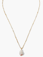 Pale iolite beaded necklace with gold accents and a large, irregular pinkish pearl pendant.