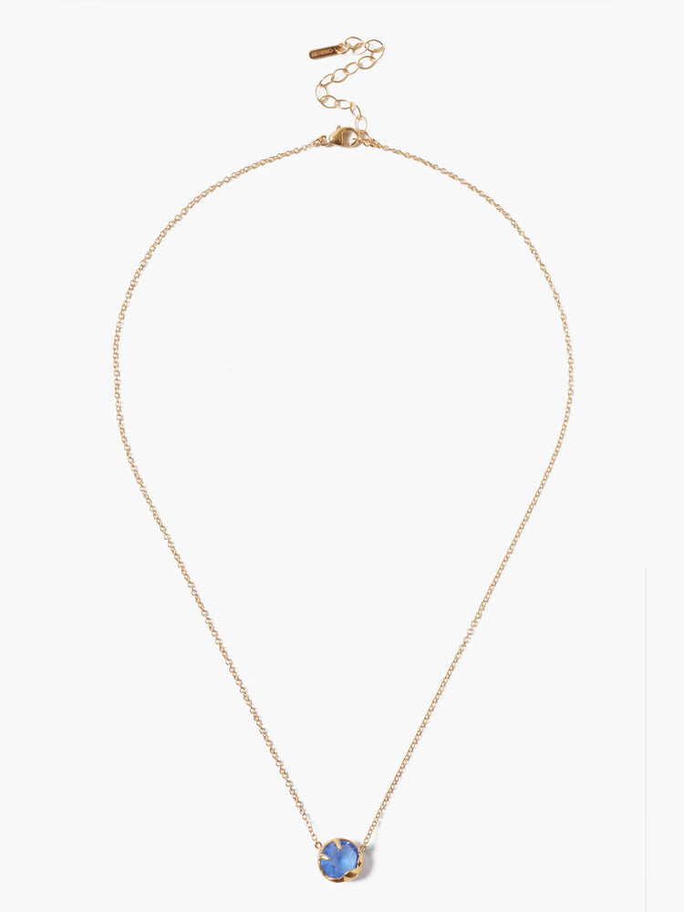Gold chain necklace with a single, round, light blue stone pendant.