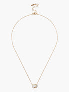 Gold chain necklace with a single, round, off-white stone pendant.