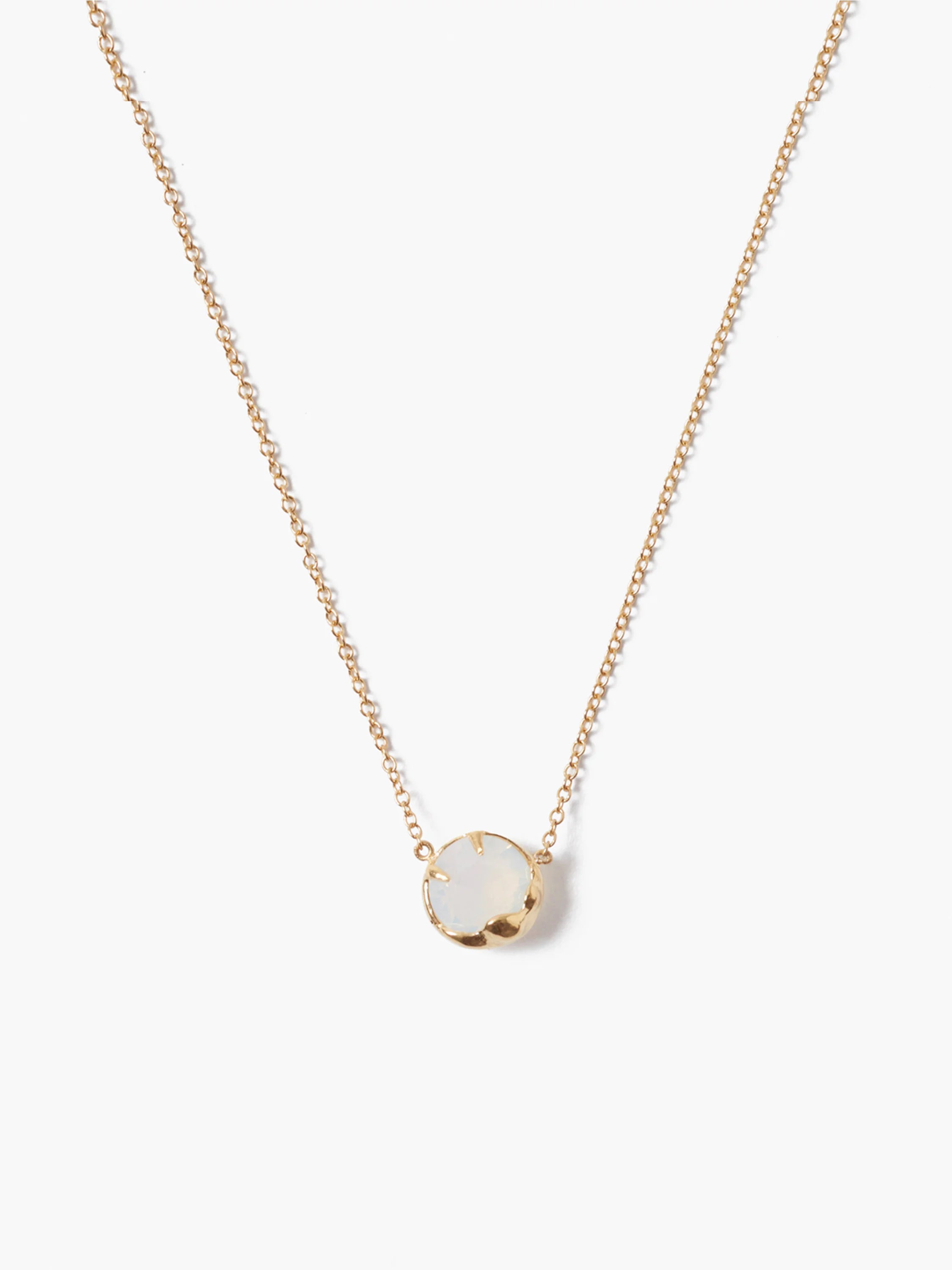 Gold chain necklace with a single, round, opaque white stone.