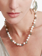 Choker-length necklace with white pearls, varied grey-green stones, and gold accents.