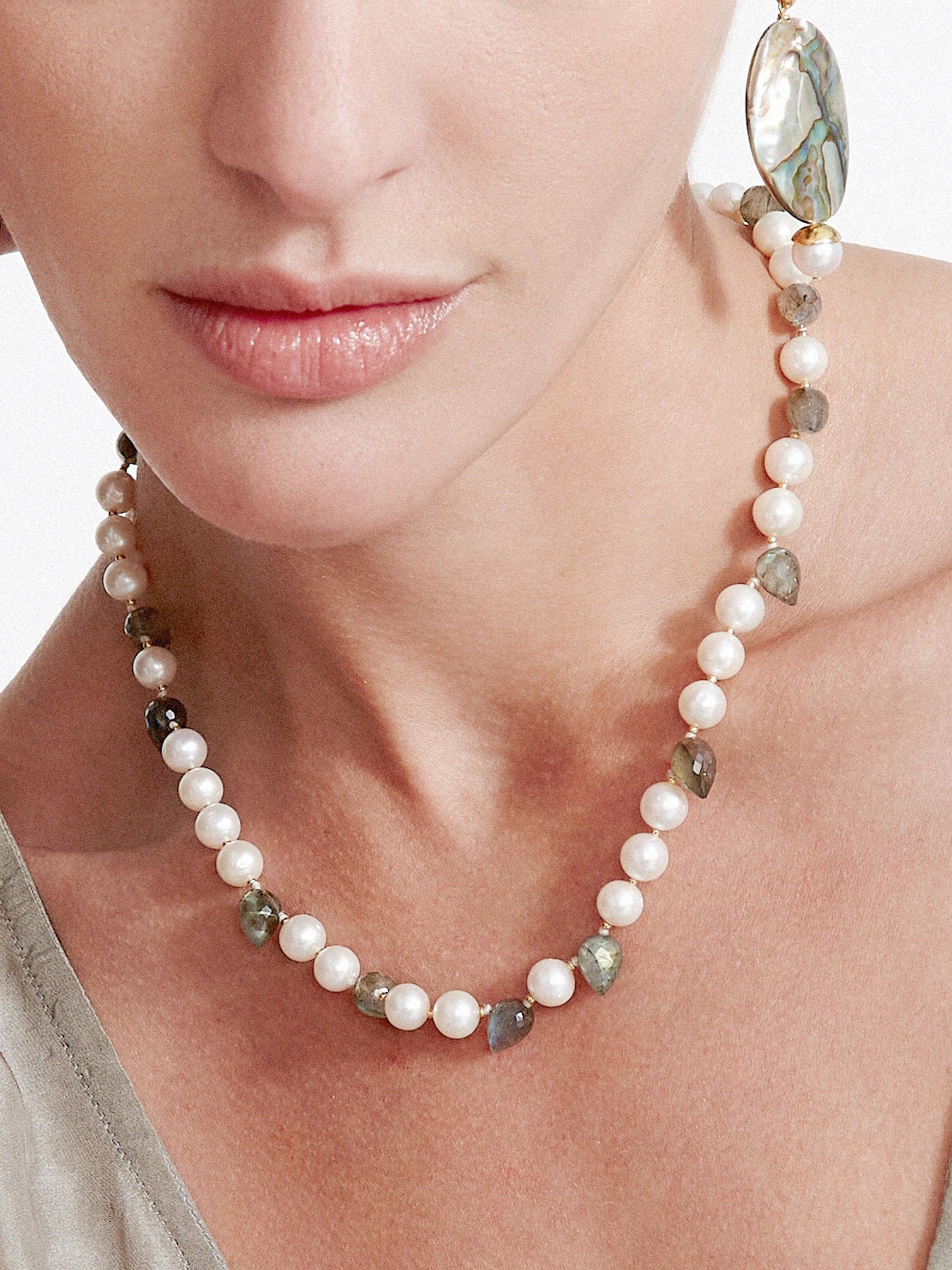 Choker-length necklace with white pearls, varied grey-green stones, and gold accents.