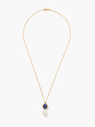 Gold chain necklace with oval dark blue kyanite, flanked by two small pearls & a large baroque pearl below.