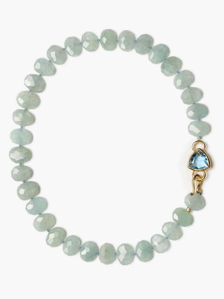 Faceted pale blue-green oval bead necklace. Gold hook clasp features a triangular bright blue gemstone.