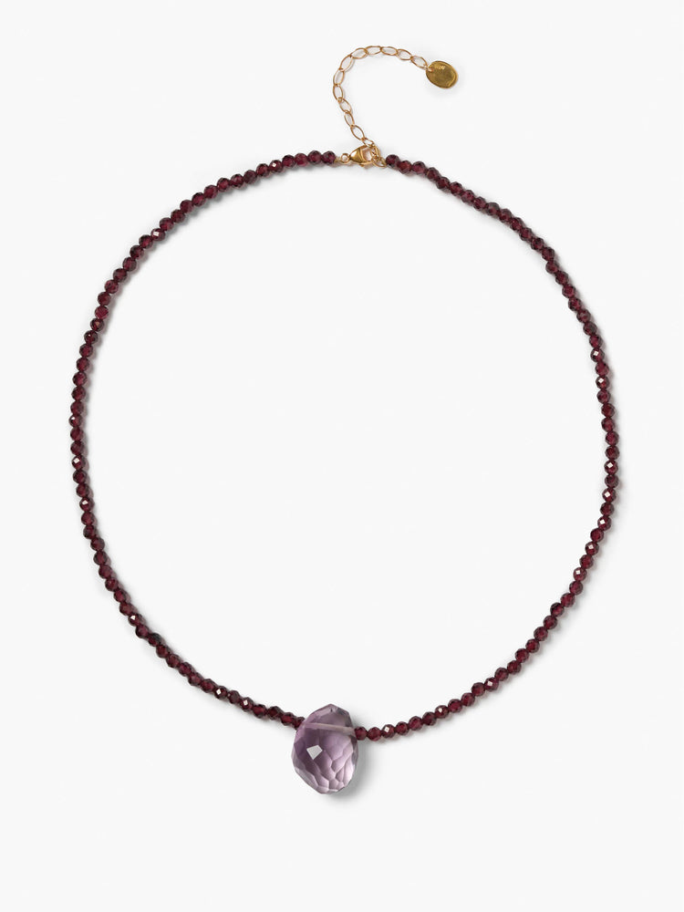 Faceted dark red garnet beaded necklace with a central faceted light purple tear-drop pendant. Gold-tone clasp.