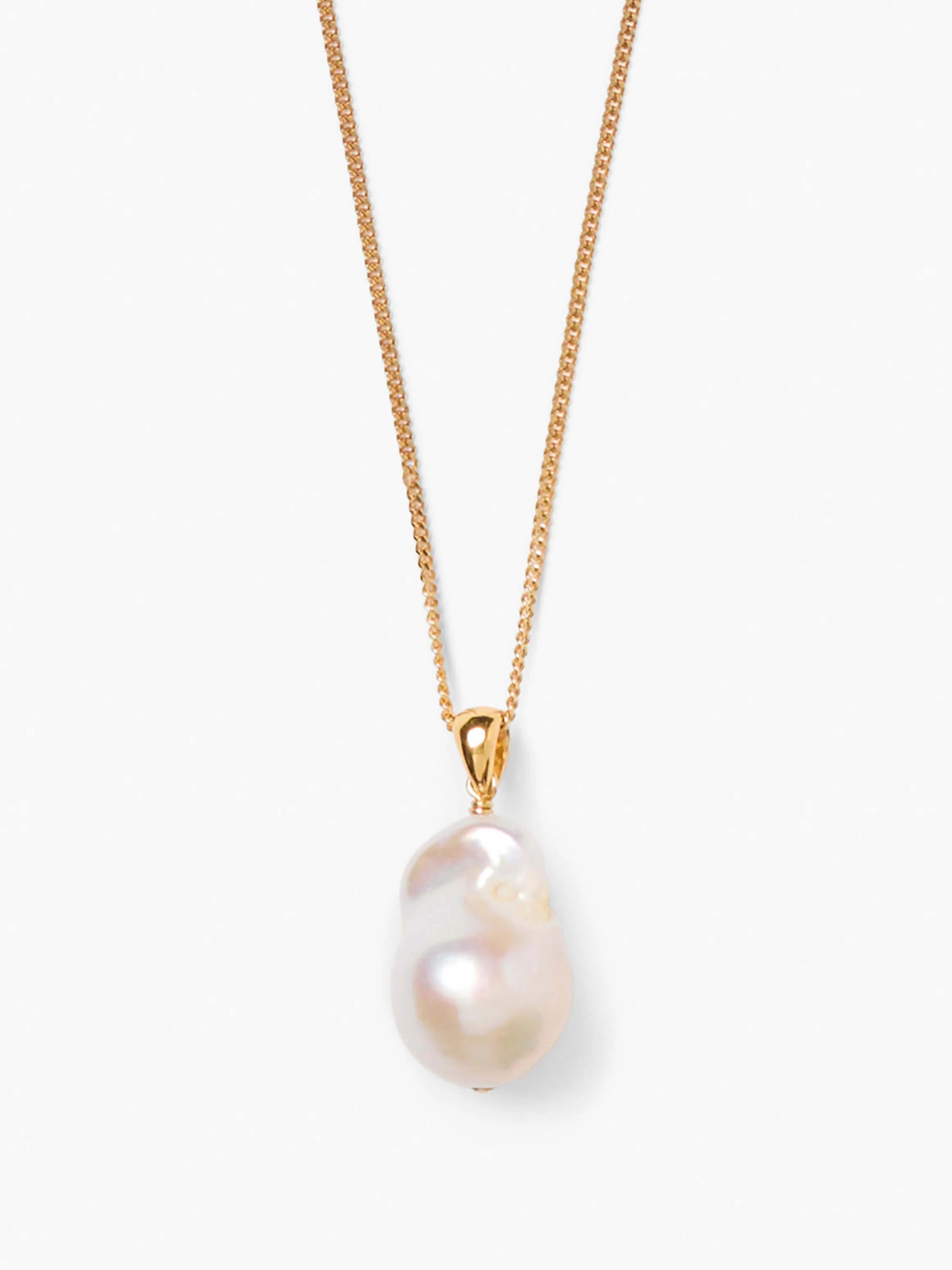 Gold chain necklace with a single, iridescent off-white baroque pearl drop pendant.