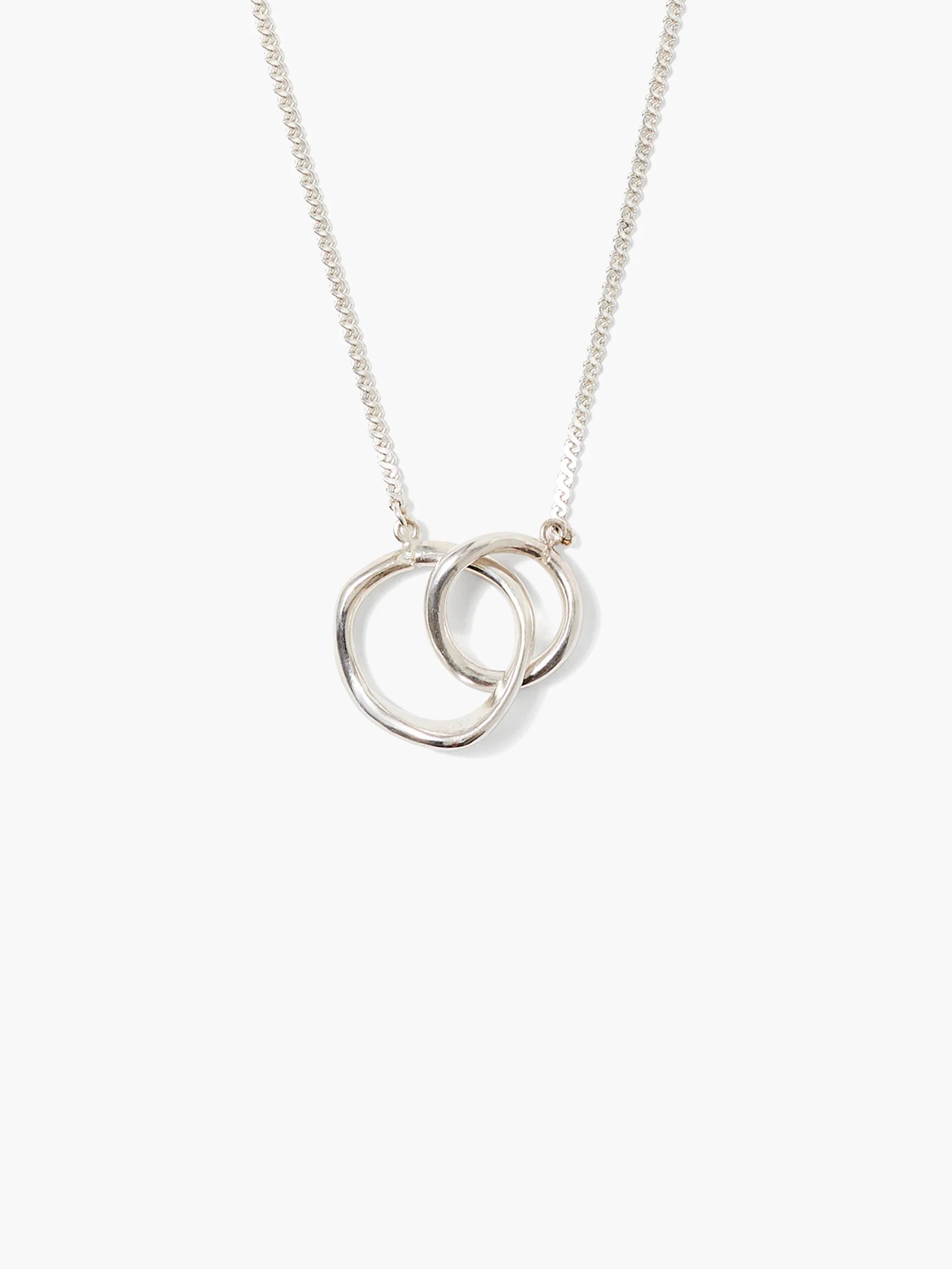 Silver-toned necklace with two interlocking loops, one irregular and one round, on a delicate link chain.