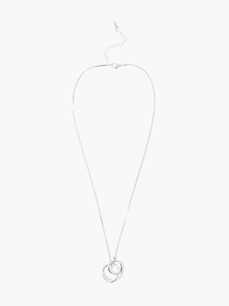 Silver necklace with two interlocking loops; one loop is organically shaped, the other is round.