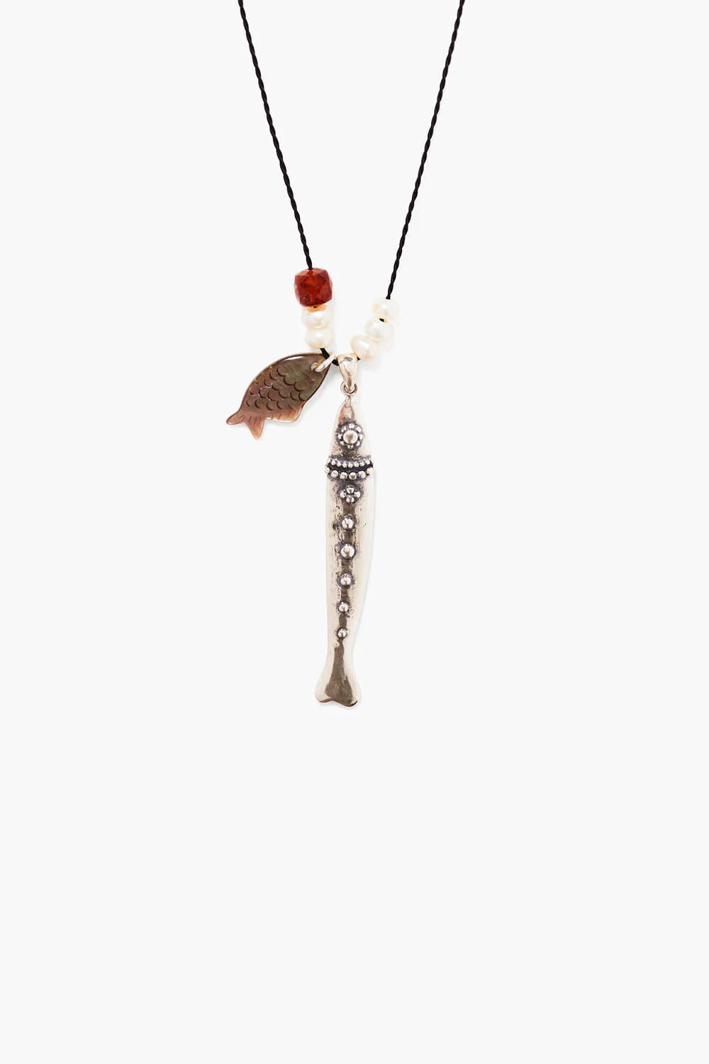 Black cord necklace with white pearls, a reddish bead, a flat iridescent fish charm, and a long silver fish charm with dots.