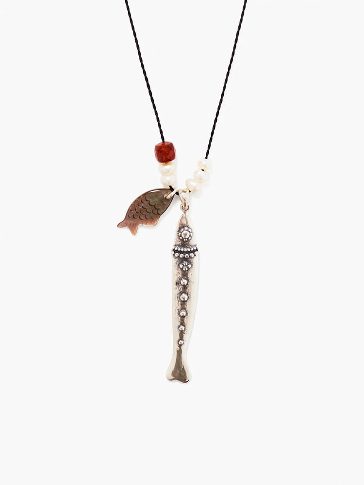 Black cord necklace with a silver textured fish charm, iridescent brown fish charm, white pearls, and a reddish bead.
