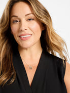 Silver necklace with a small lock charm featuring tiny clear stones and a matching key charm.