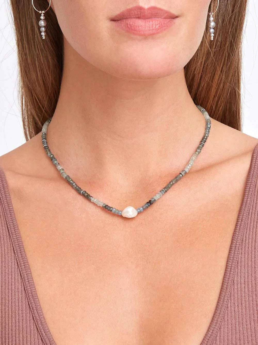 Aquamarine and gray beaded necklace with a single off-white pearl accent.  Silver-toned metal accents.