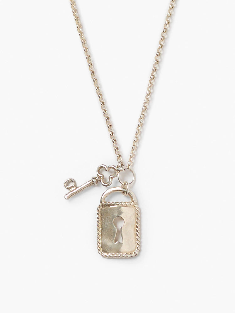 Silver-toned necklace with a delicate chain, a rectangular lock pendant with a keyhole, and a small skeleton key charm.