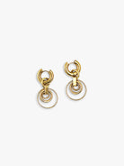 Gold-toned drop earrings. Each features a thick hoop and three dangling, interconnected rings decreasing in size.