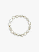 Bracelet with irregular off-white pearls and small gold beads.