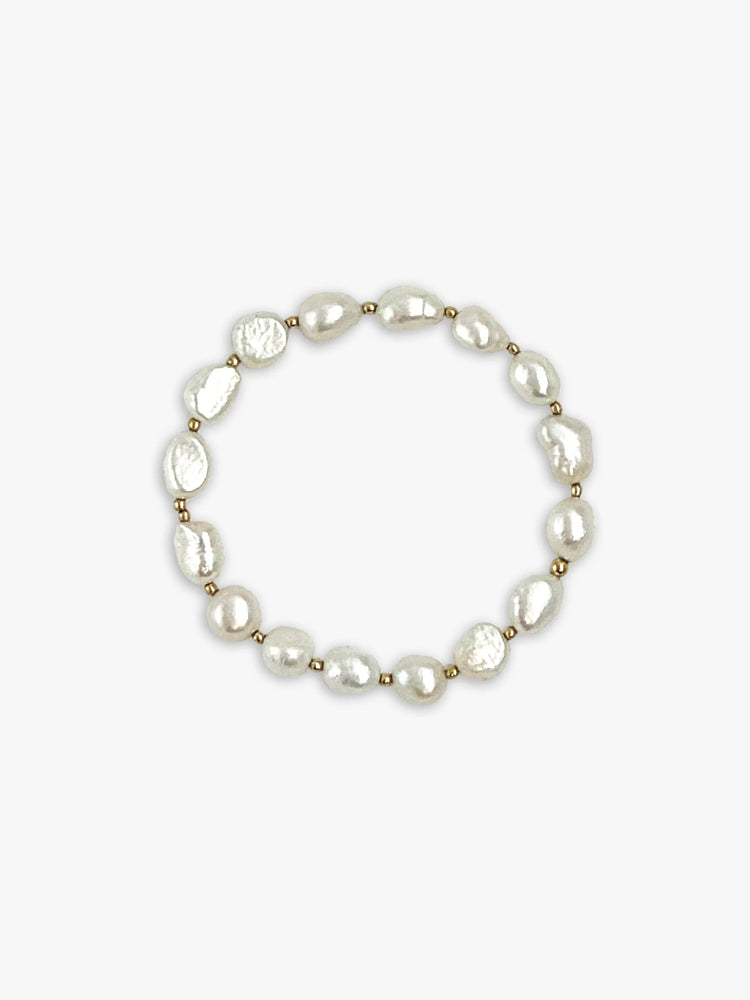 Bracelet with irregular off-white pearls and small gold beads.