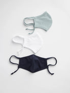 Three cloth face masks: light blue, white, and navy.  Each has ear loops and ties.