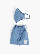 Heather blue knit mask with navy trim & ear loops, and matching drawstring bag with navy tie & brand label.