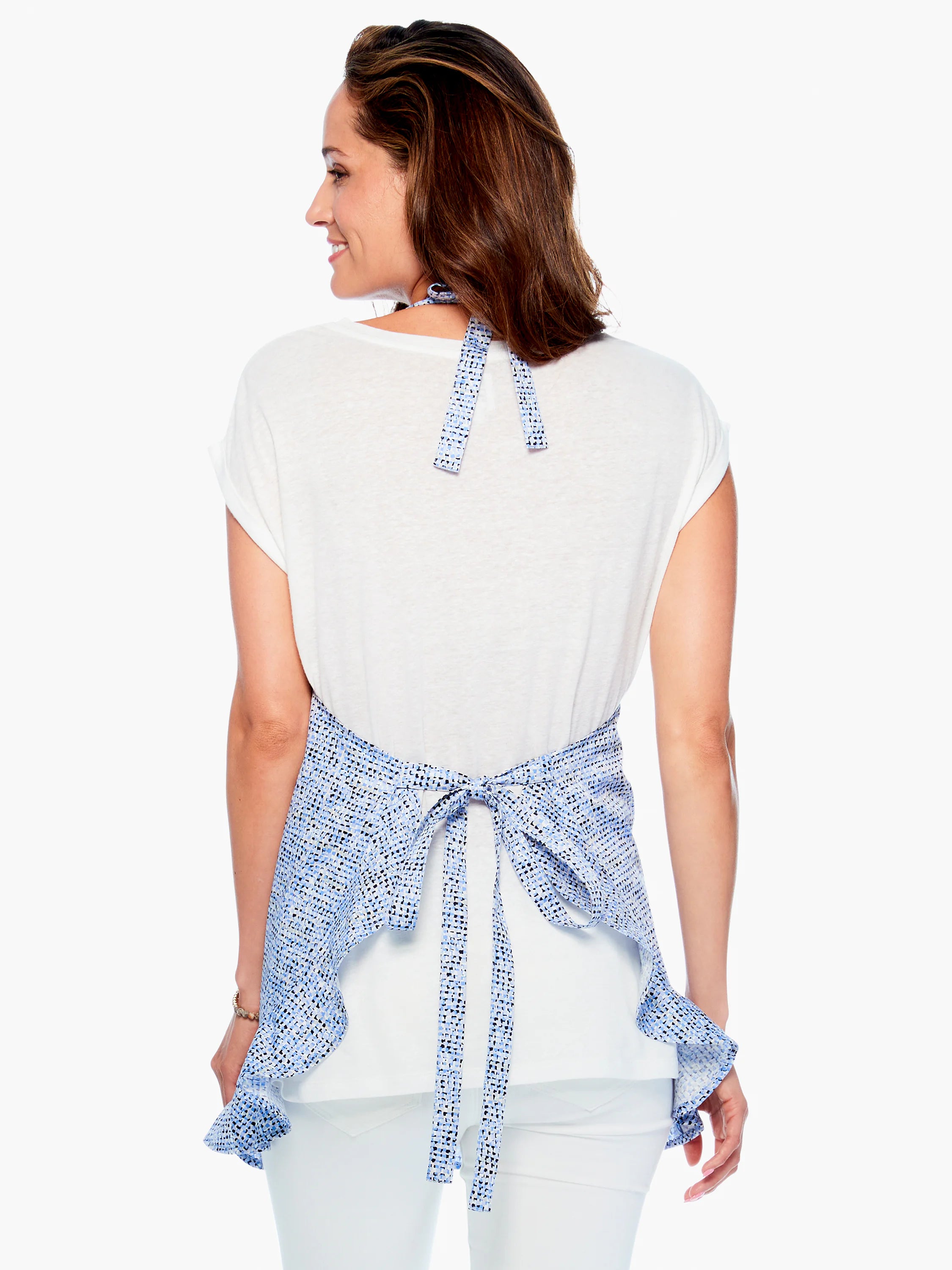 Blue and white patterned apron with ruffled hem and tie closure.  Seen from the back.
