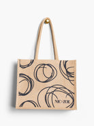 Beige jute tote bag with black swirling circle pattern and "NIC+ZOE" logo.  Natural fiber texture.