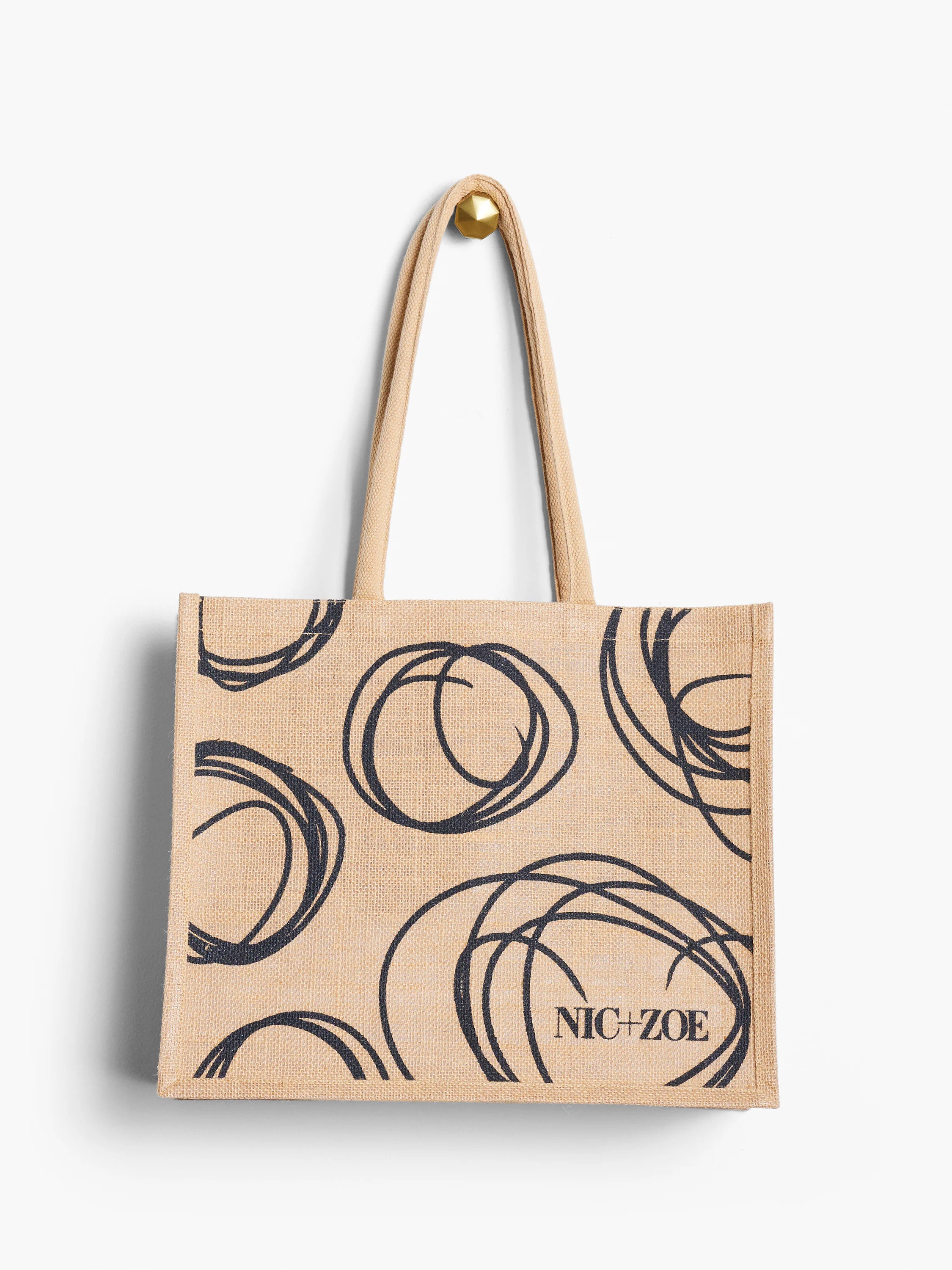 Beige jute tote bag with black swirling circle pattern and "NIC+ZOE" logo.  Natural fiber texture.